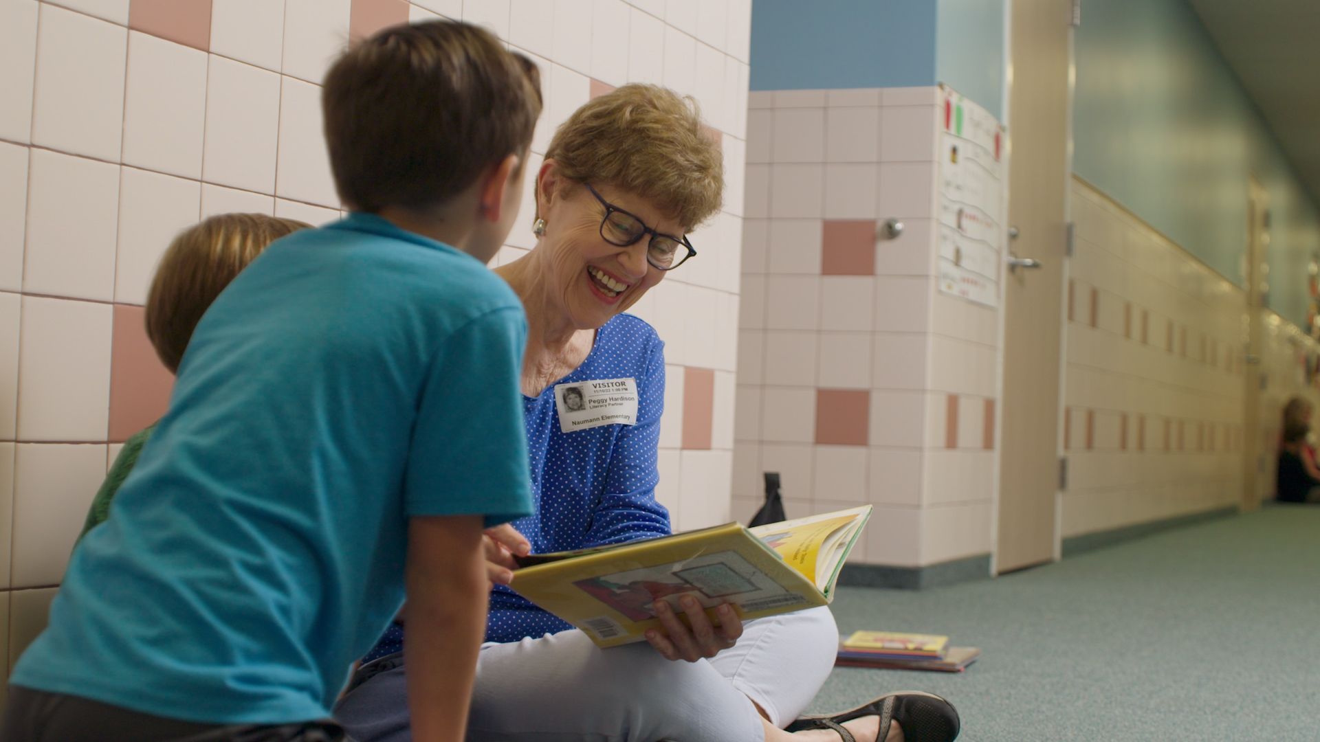 A Literacy Partner reading one-on-one with a student